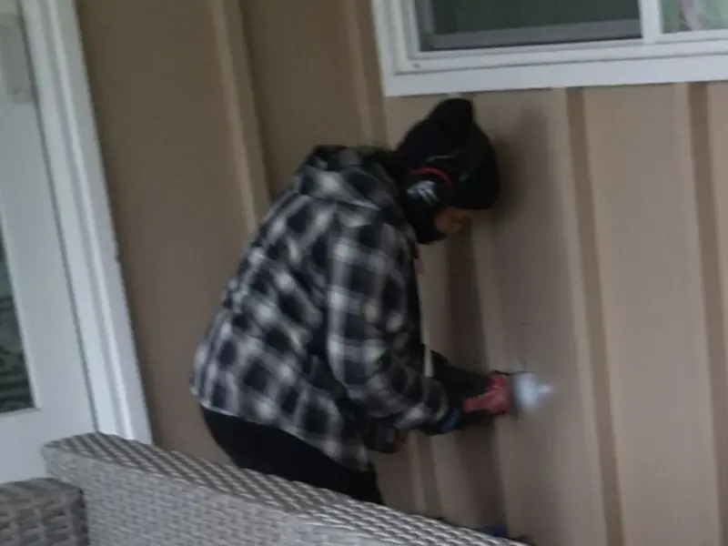 Professional electrician installing an exterior outlet in Parsons