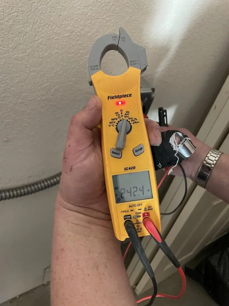 Voltage testing with clamp meter during Outlet Installation in Parsons